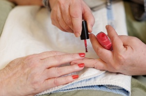 Tree of Life Senior caregiver is painting nails for senior